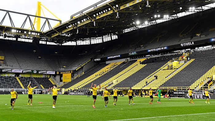 Dortmund players salute the empty Yellow Wall at Signal Iduna Park